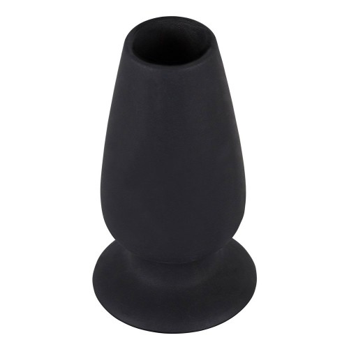 black anal plug, that is open on both sides. length: approx. 10 cm, penetration depth 8.5 cm. Outer Ø 3 to 5 cm, inner Ø 2.5 cm. Material: silicone.